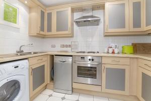 a kitchen with a washing machine and a washer at Strand House- Long Stays only in York