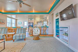 a living room with a tv and a table and chairs at A Blessing by Meyer Vacation Rentals in Fort Morgan