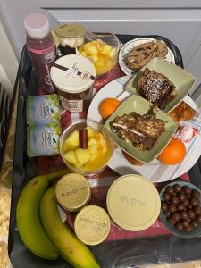 a tray with a variety of food and fruit on it at SUITE spa accès autonome in Beaucaire