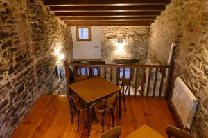 a room with a table and chairs on a balcony at UNDUESINA Albergue Undués de Lerda in Undués de Lerda