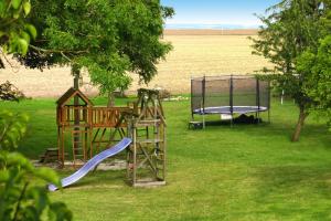 a playground with a slide and a trampoline at Cottage, Vieregge in Vieregge