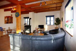 a living room with a leather couch and a table at Cottage, Vieregge in Vieregge