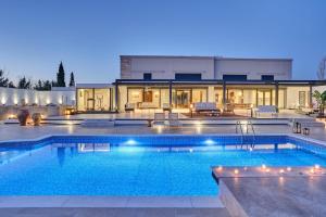 a large swimming pool in front of a house at Sia Mare Residence in Faliraki