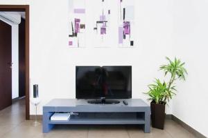 a living room with a tv on a table at T2 PORTICCIO AGOSTA PLAGE 100M DE LA PLAGE in Porticcio