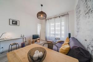 a living room with a couch and a table at Brand new one bedroom heart of Cannes!! in Cannes