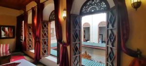 a room with an open window with a view of a balcony at Riad Dar Zaya in Marrakesh
