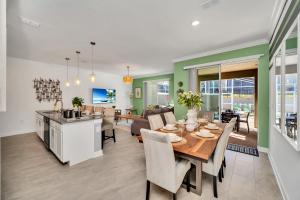 a dining room and living room with a table and chairs at 1030 Splash Shot Place in Kissimmee