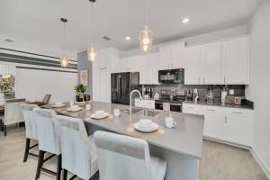 a kitchen and dining room with a table and chairs at 1030 Splash Shot Place in Kissimmee