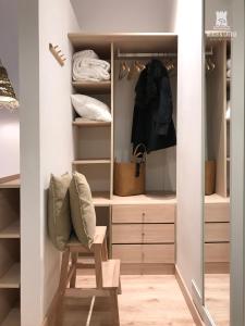a walk in closet with a bench and a chair at Beach & Castle - Sines Apartment in Sines
