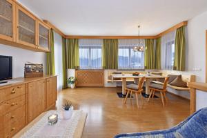a living room with a table and a dining room at Obergasserhof in Rodengo