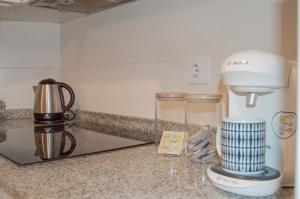 a kitchen counter with a coffee maker and a blender at NOVAM Heredia in Málaga