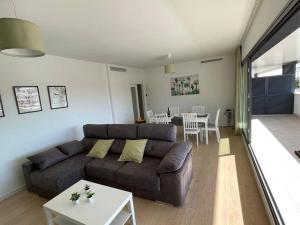 a living room with a couch and a table at Holidays2Torremolinos Alamos 3 bedroom & terrace & pool in Torremolinos