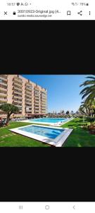 a picture of a large swimming pool with buildings at Apartment PYR in Fuengirola