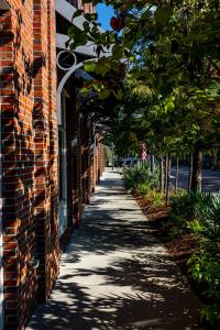 a sidewalk next to a brick building at The Inn At The Crossroads in Lake City