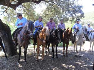 a group of men sitting on horses under a tree at Casa Annette in Cortelazor