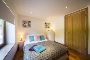 a bedroom with a bed with two pillows on it at Ashbrook Lets Apartments in Blewbury