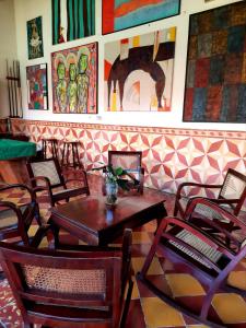 a restaurant with tables and chairs and paintings on the wall at Hotel La Posada del Doctor in León