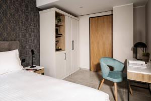a bedroom with a bed and a desk and a chair at Amery House in Sliema