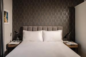 a bedroom with a large bed with two night stands at Amery House in Sliema