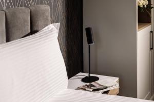 a bedroom with a bed and a nightstand next to a bed sidx sidx sidx at Amery House in Sliema