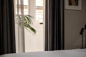 a bedroom with a bed and a window at Amery House in Sliema
