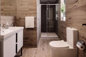 a bathroom with a shower and a toilet and a sink at Amery House in Sliema