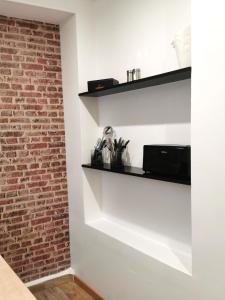 a room with a brick wall and shelves at CHIC & WORK in Albert