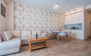 a living room with a couch and a table at New Gudauri Alpic 406 in Gudauri