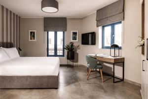 a hotel room with a bed and a desk at Amery House in Sliema