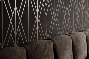 a row of chairs against a wall with gold lines at Amery House in Sliema