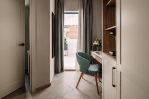 a room with a chair and a desk and a window at Amery House in Sliema
