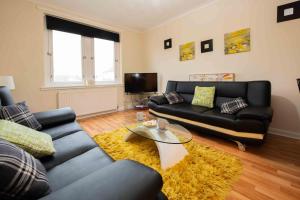 a living room with a couch and a table at PREMIER - Chapel House with Driveway! in Cleland