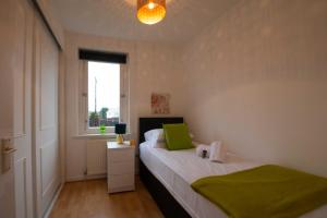 a small bedroom with a bed and a window at PREMIER - Chapel Street Apartment in Cleland