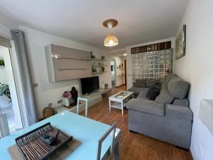 a living room with a couch and a table at APARTAMENTO PINAR de MONTEMAR in Torremolinos
