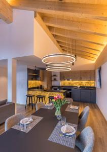 a dining room and kitchen with a table and chairs at Haus zur Brücke in Zermatt