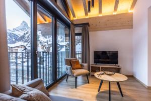 a living room with a view of a mountain at Haus zur Brücke in Zermatt