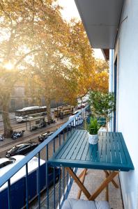 a blue table on the balcony of a building at Riverside 2 Bedroom Apartment by DA'HOME in Porto