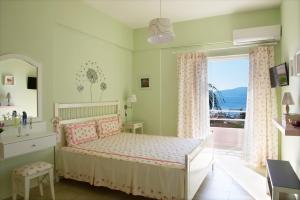 a bedroom with a bed with a view of the ocean at Mirella Studios in Loutra Oraias Elenis 