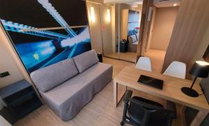 a small living room with a couch and a table at Alphaville Stay Residences in Barueri
