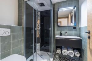 a bathroom with a shower and a sink at Haus zur Brücke in Zermatt