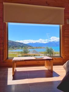 a large window with a view of the water at El Arrayan in Puerto Guadal