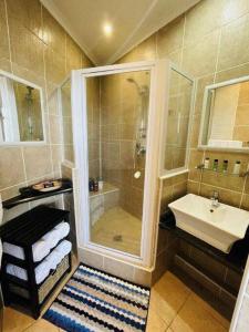 a bathroom with a shower and a sink at Penthouse 42 at Ezulweni in Amanzimtoti +13 photos