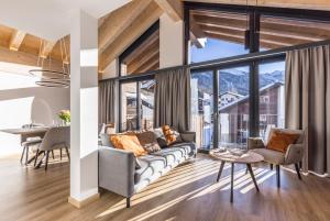 a living room with a couch and a table at Haus zur Brücke in Zermatt