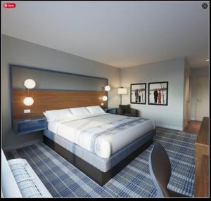a bedroom with a large bed in a room at AmericInn by Wyndham New Braunfels in New Braunfels