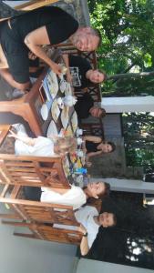 a group of people standing around a table at Maple Home Stay in Ella