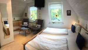 a bedroom with two beds in a room with two windows at Holiday home Groß Kordshagen/Ostsee 2774 in Flemendorf