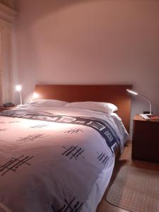 a bedroom with a large bed with a wooden headboard at Nr65 Valletta Portview Apartment in Valletta