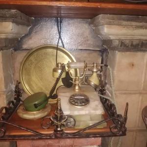 an old fashioned phone on a wall with a clock at Maison de rêve in Tabarka