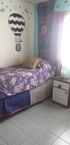 ein Schlafzimmer mit einem Bett mit einem Ballon an der Wand in der Unterkunft Habitación en casa in San Carlos de Bariloche