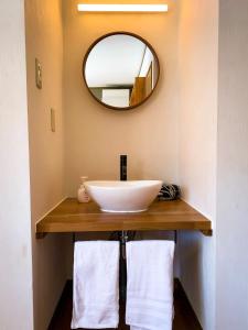 a bathroom with a sink and a mirror at La Colina Retreat - Vacation STAY 07206v in Madarao Kogen